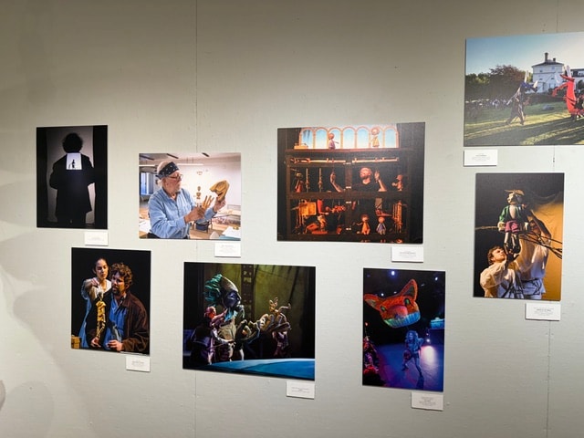 Gallery wall with framed photographs of performers — Kent CT Puppetry Exhibit