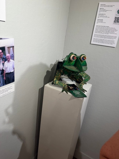 Green frog sculpture on pedestal — Kent CT Puppetry Exhibit