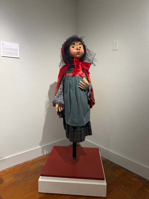 Handmade doll on red platform — Kent CT Puppetry Exhibit
