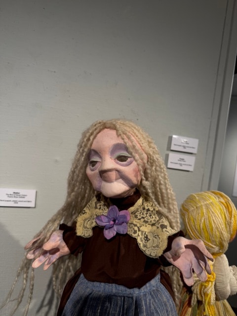 Handmade doll puppet with blonde braided hair and purple flower — Kent CT Puppetry Exhibit