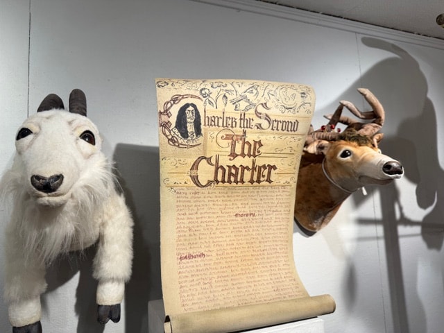 Puppet animals flanking The Charter scroll — Kent CT Puppetry Exhibit