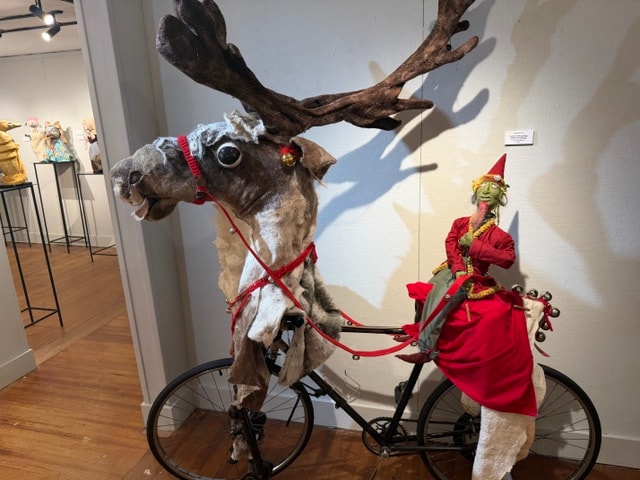 Reindeer and elf puppet riding a bicycle — Kent CT Puppetry Exhibit